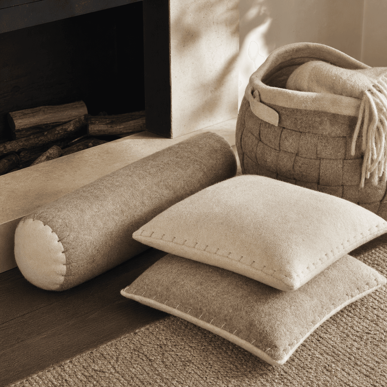 Fireside Warmth Set — A wool-felt draught excluder, two cushion covers and a felt basket to keep the warm in and the draughts out.